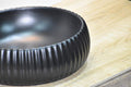 Bathroom with bowl sink close-up of matte black round ceramic vessel basin, smooth rim detail for vanity top