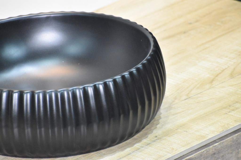 Bathroom with bowl sink close-up of matte black round ceramic vessel basin, smooth rim detail for vanity top