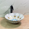 Mexican hand painted sink close-up of glossy blue yellow Talavera pottery pattern on ceramic round basin