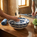 Close-up of glossy Mexican Blue finish on round ceramic bathroom sink bowl, smooth rim detail