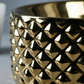 Vessel sink on vanity close-up of smooth rim, glossy gold ceramic oval bowl sink