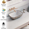 Over counter bathroom sink interior view, glossy rose gold ceramic rectangular vessel bowl with drain opening