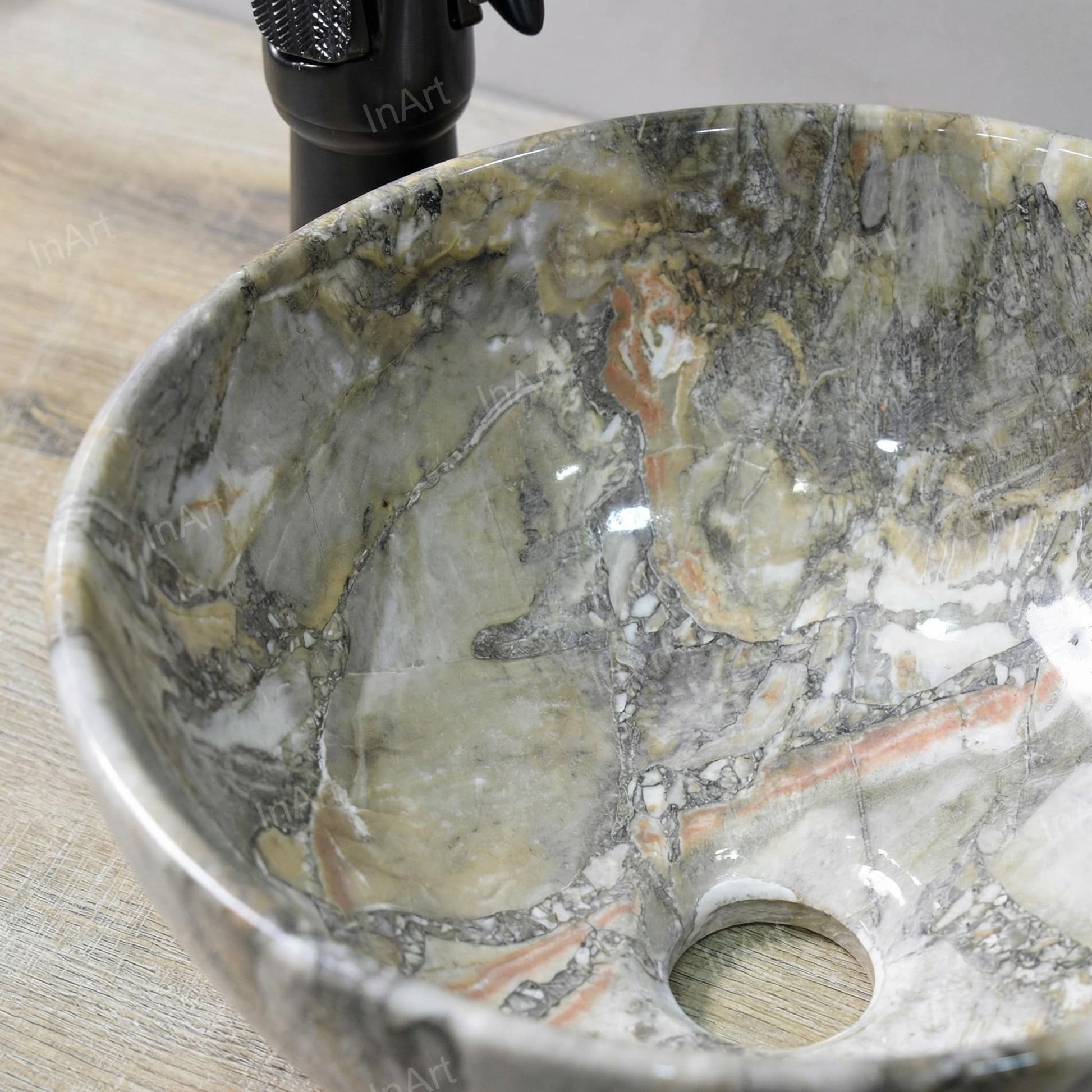 Bathroom sink on top of vanity lifestyle with round ceramic vessel sink, green marble finish and faucet pairing