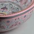 Detail of glossy pink ceramic oval vessel sink rim, pairs with faucet for vessel sink on modern vanity