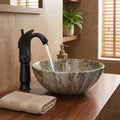 Above counter bathroom sink detail showing glossy green marble pattern on round ceramic vessel basin