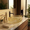 InArt gold bowl sink detail, oval glass basin rim and drain area for modern bathroom vanity with vessel sink