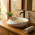 Ceramic oval vessel sink detail, glossy marble pattern finish - above counter sink rim close-up