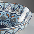 Modern vessel sink styled on vanity, round ceramic bowl sink with blue Mexican design