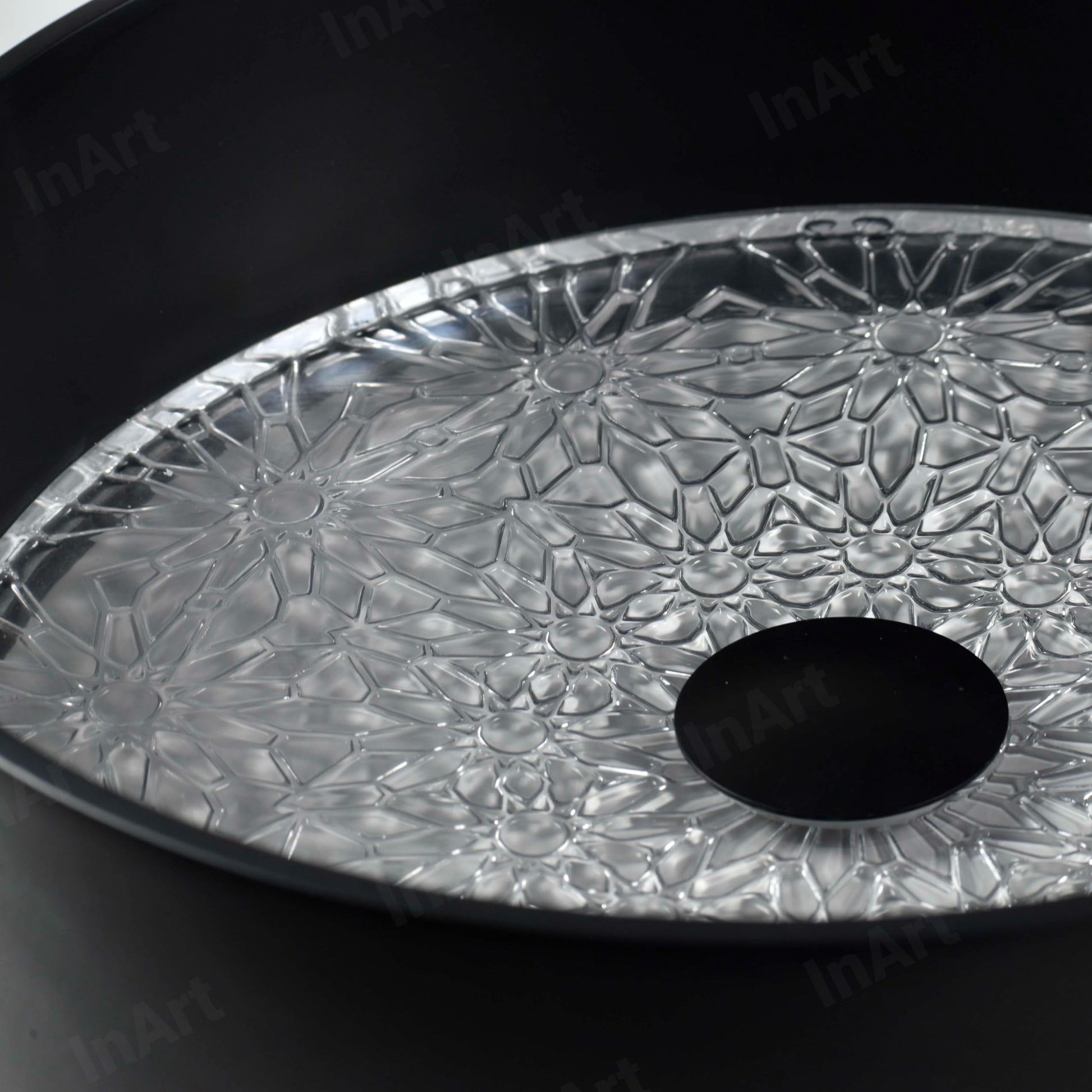 Designer round vessel sink on vanity, matte black glass bowl showing clear patterned textured base detail
