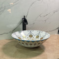 Mexican ceramic sink drain detail on round glossy Talavera pottery vessel basin, blue and yellow pattern