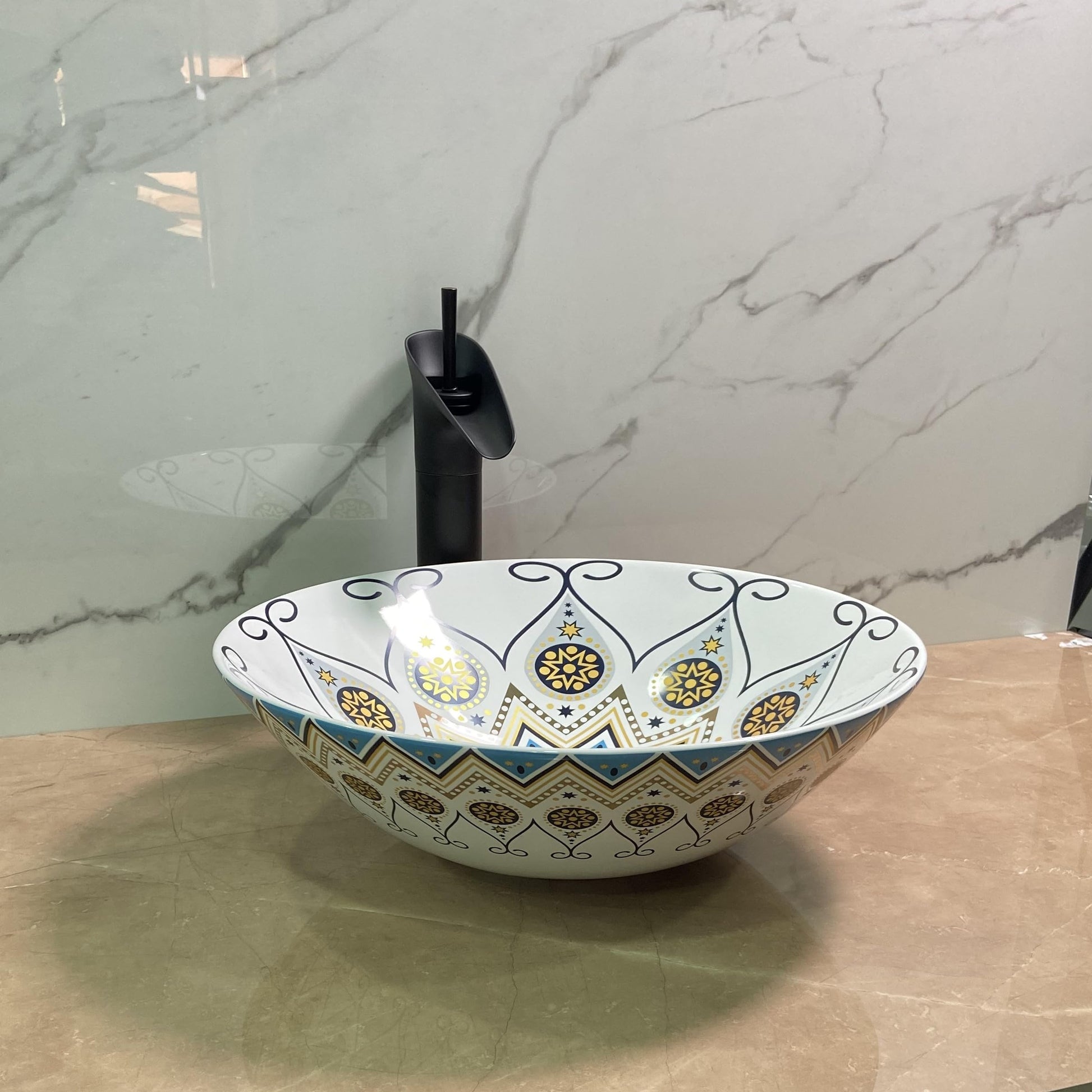 Mexican ceramic sink drain detail on round glossy Talavera pottery vessel basin, blue and yellow pattern