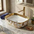 Close-up of gold rim on glossy white ceramic vessel bathroom sink, oval bowl sink detail